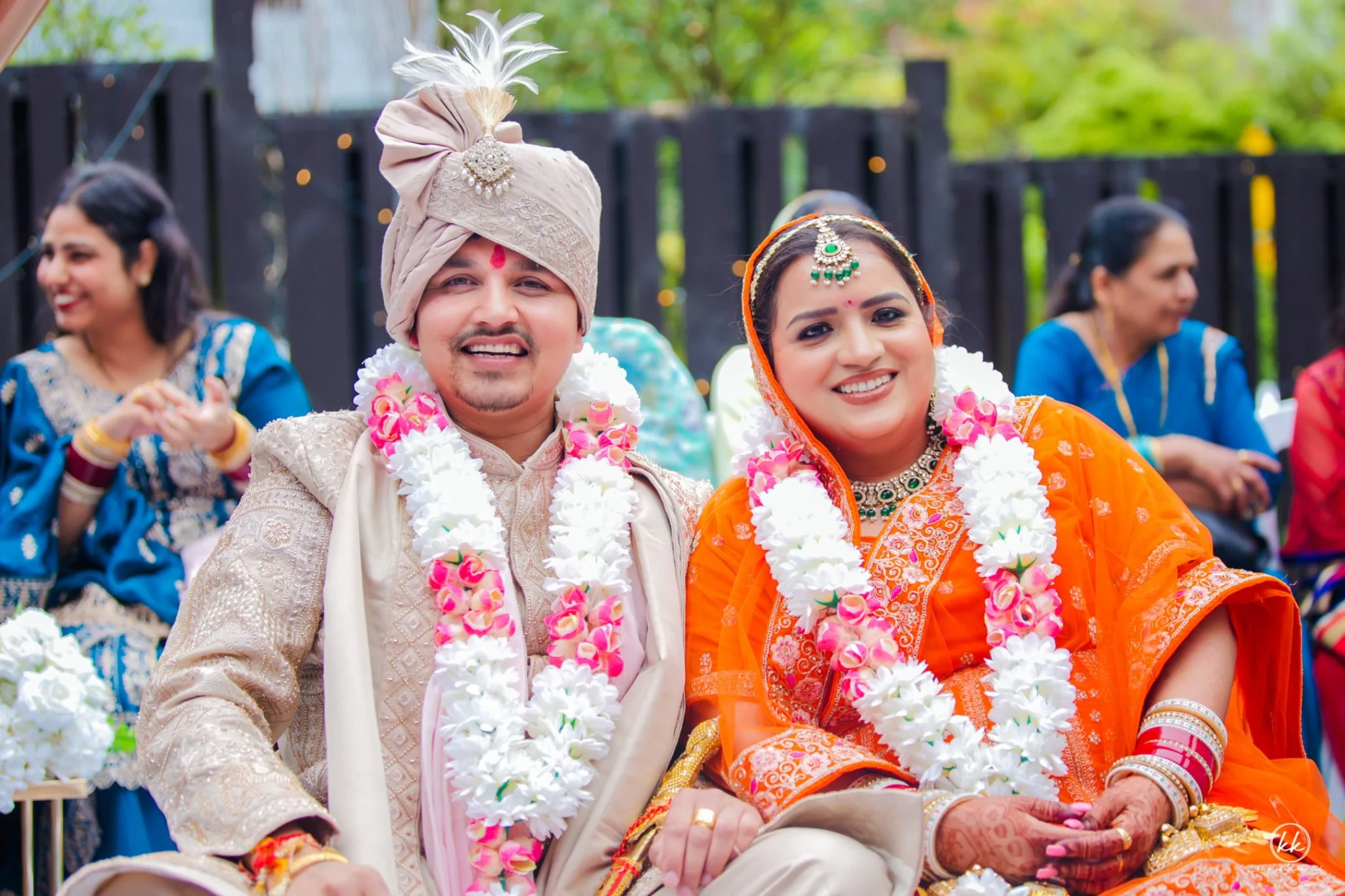 Bride and groom smiling during their traditional Indian wedding ceremony captured by KK Productions