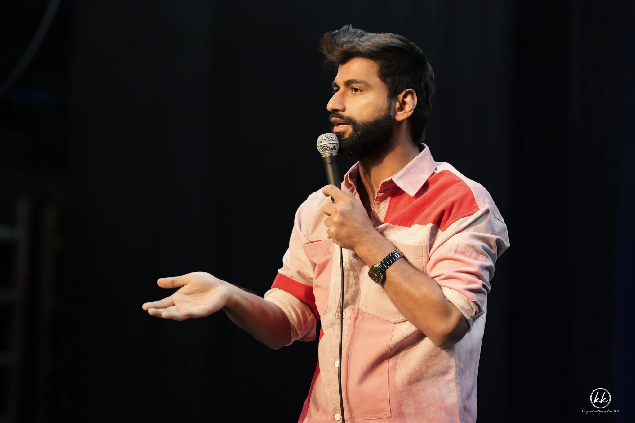 Close-up of Harsh Gujral performing live on stage during a comedy event